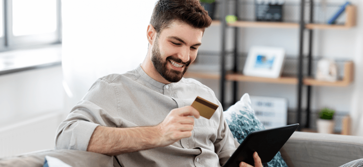 Man watching his credit card with smile